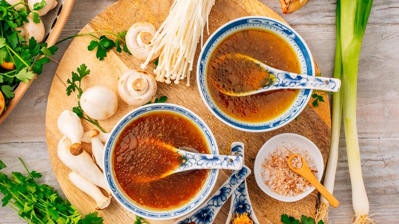 Bowls of broth with ingredients