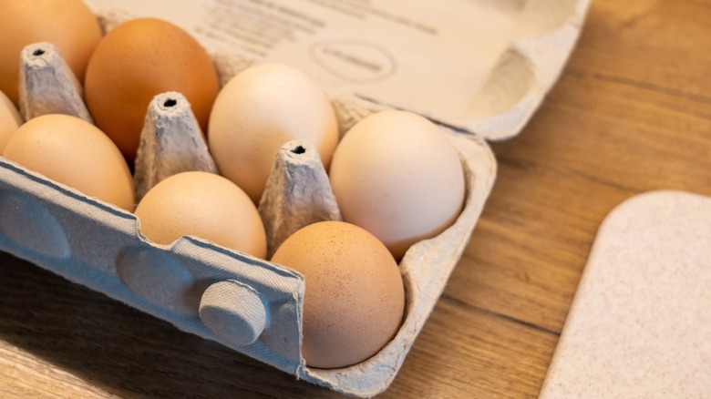 eggs in carton wooden board