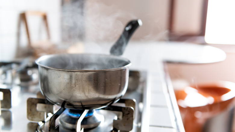 saucepan on stovetop with steam 