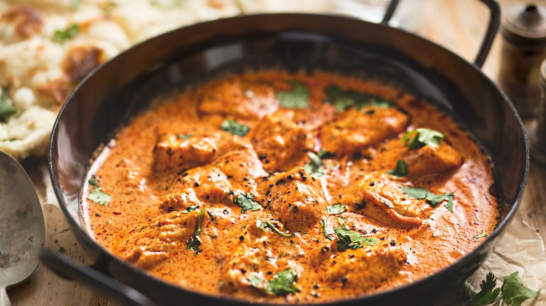 Butter chicken in black pan