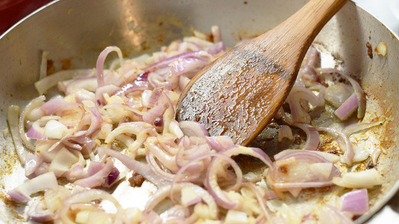 Sliced onions cooking in pan