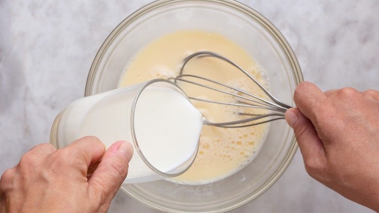 adding milk to eggs