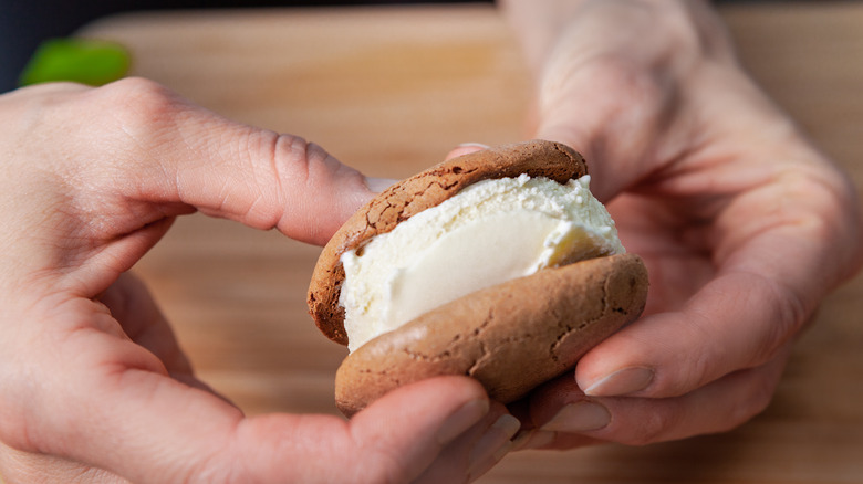 Hands holding ice cream sandwich 