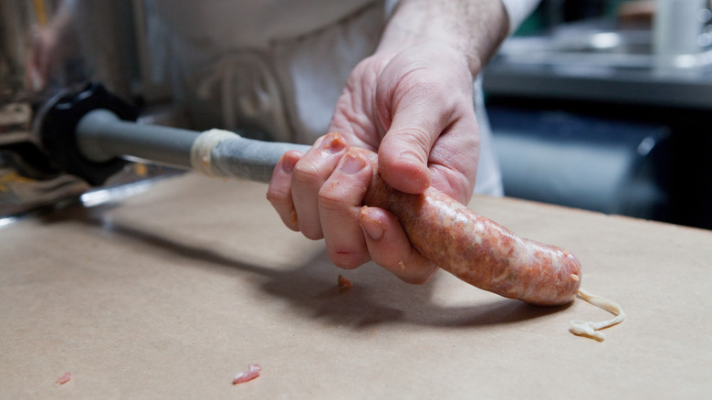 stuffing sausages into casings