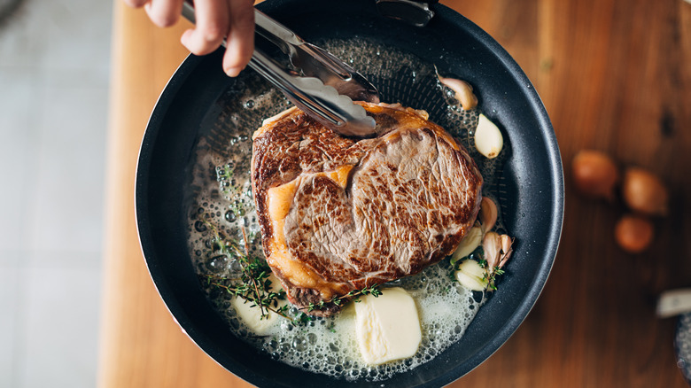 Steak cooking in butter and oil