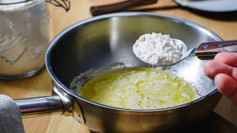 Adding flour to roux in pan