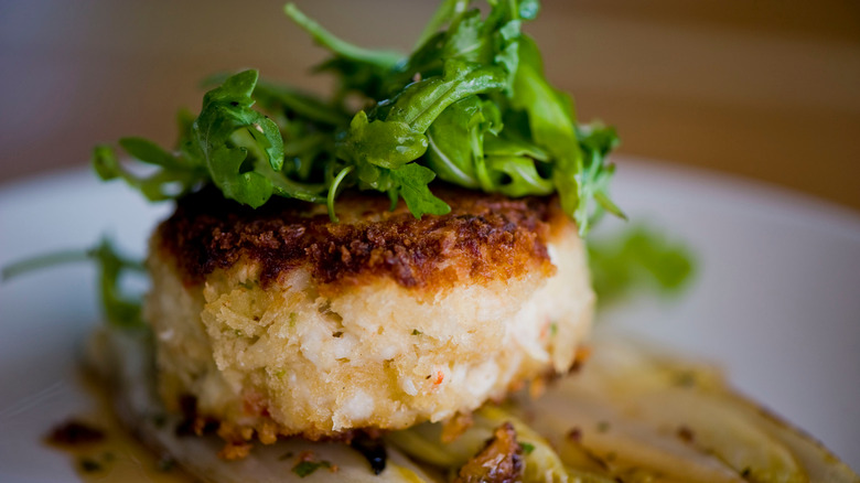 Crab cake topped with arugula