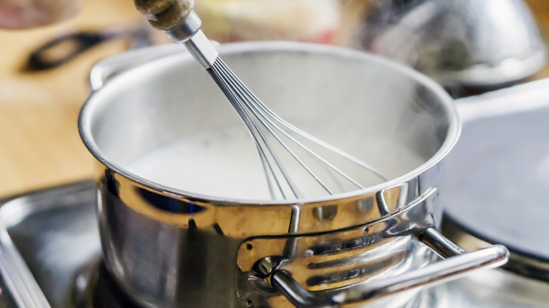 milk in pot with whisk
