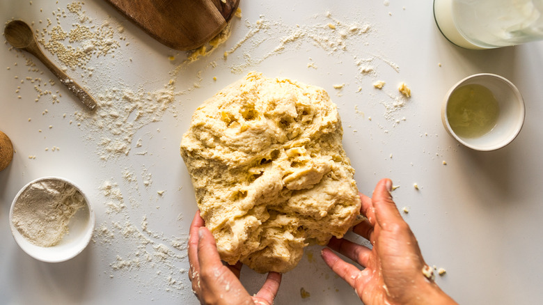 hands working dough on counter