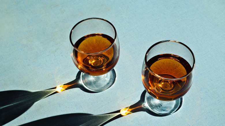 Two brandy snifters containing armagnac