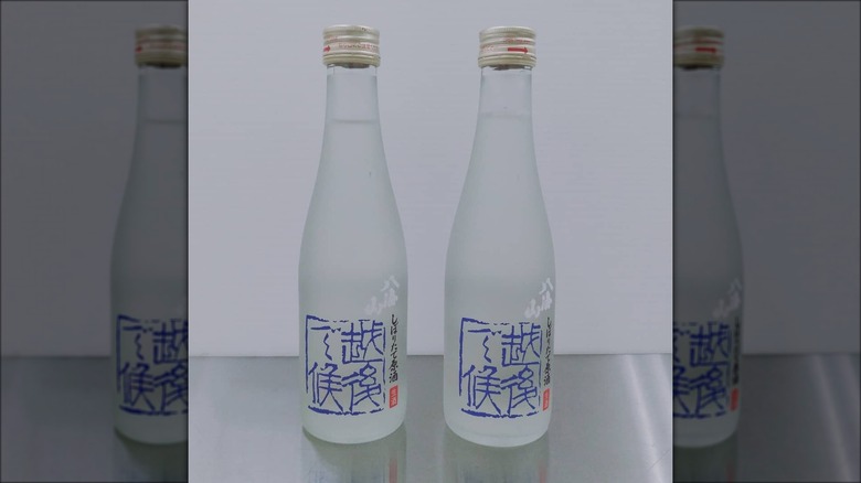 Two Hakkaisan sake bottles side by side