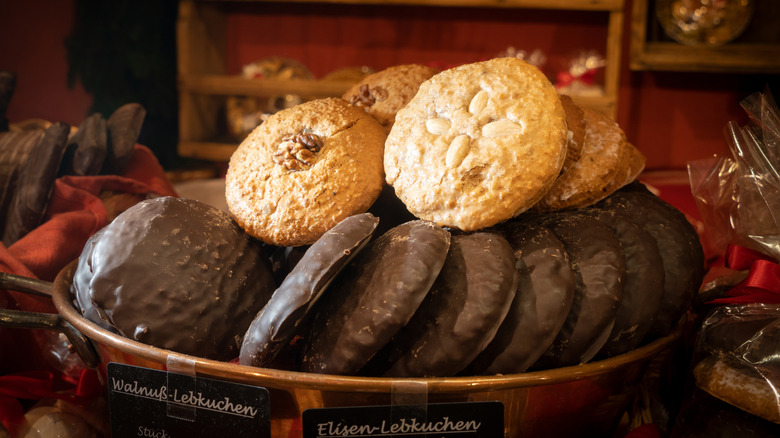 Various types of German lebkuchen gingerbread cookies stacked in a bowl at a Christmas market stall