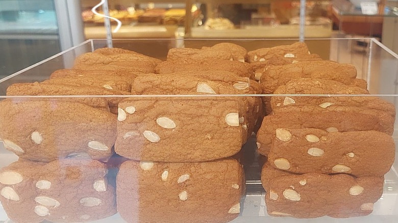 Pains d'amandes French and Belgian cookies stacked in a glass container at a French bakery