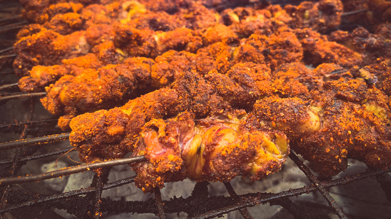 Skewered suya being grilled