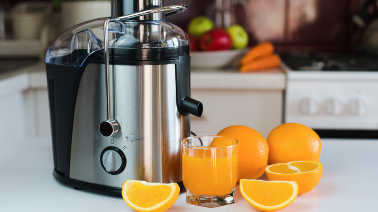 orange juice, oranges and juicer