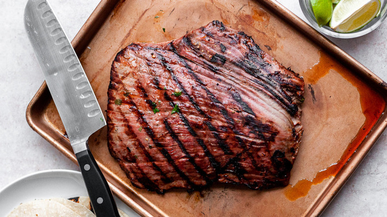 Carne asada on baking sheet ready to slice