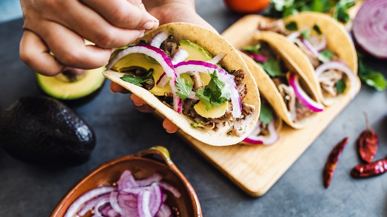 making tacos with corn tortillas