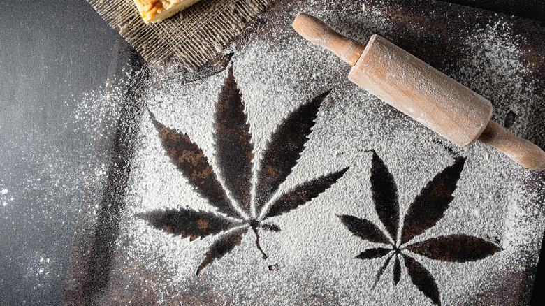 Cannabis leaf silhouette in flour on table