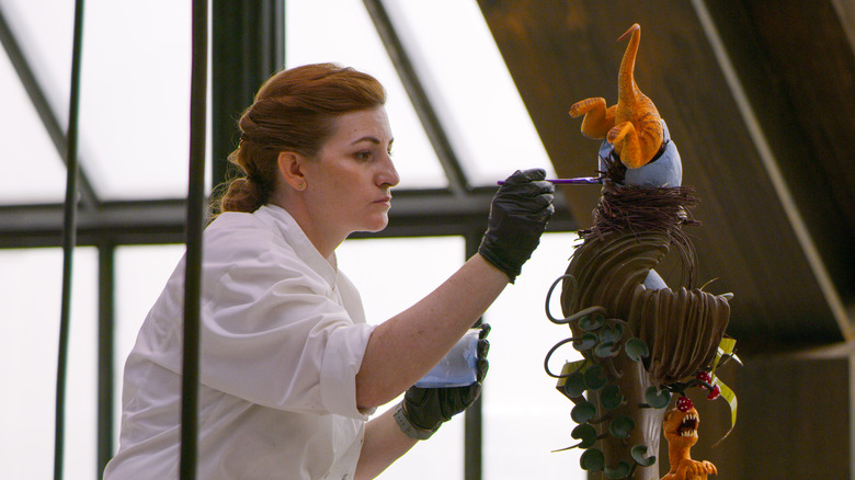 Female chocolatier creating chocolate sculpture