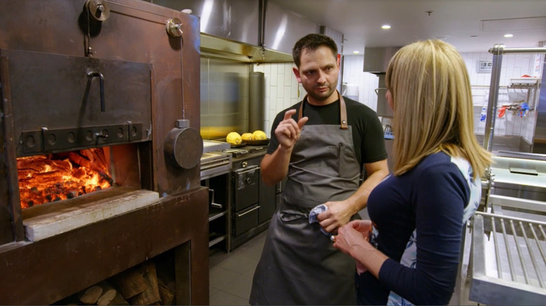 Chef explaining wood-fired cooking