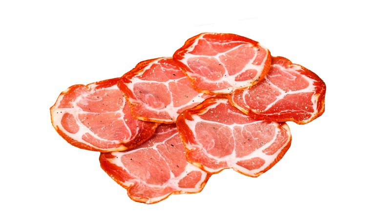 Slices of jamon lomo with white background