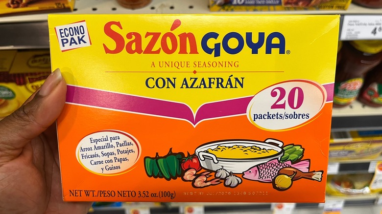 Hand holding pack of Sazón Goya