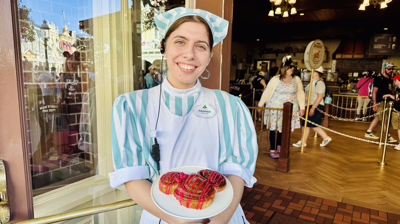 Cast member with cinnamon roll