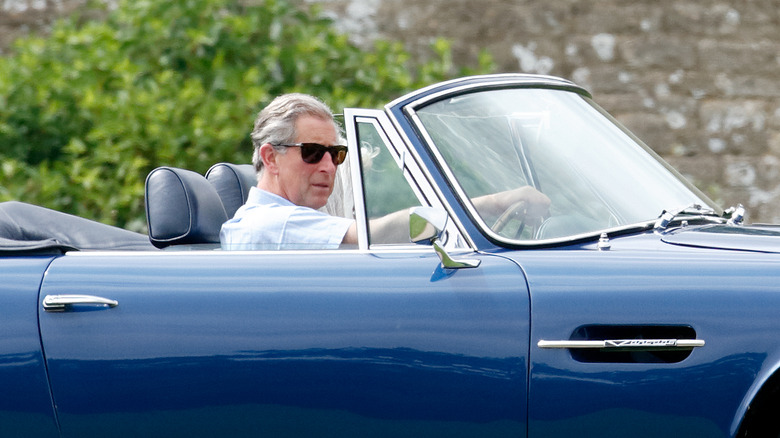 King Charles driving Aston Martin