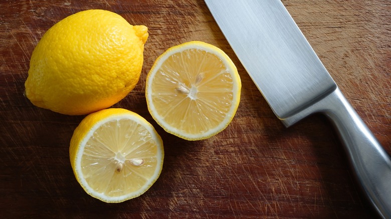 Sliced lemon with a knife