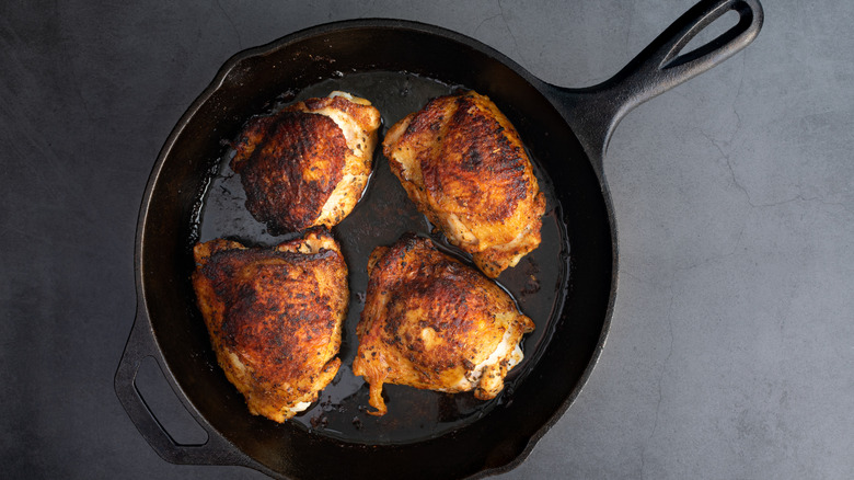 Chicken thighs in pan