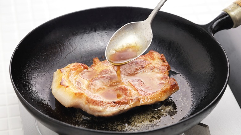 Butter basting pork in skillet