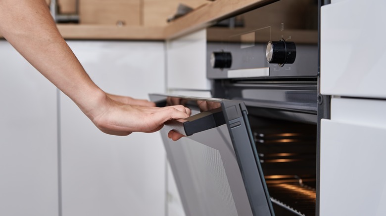 Person opening oven door