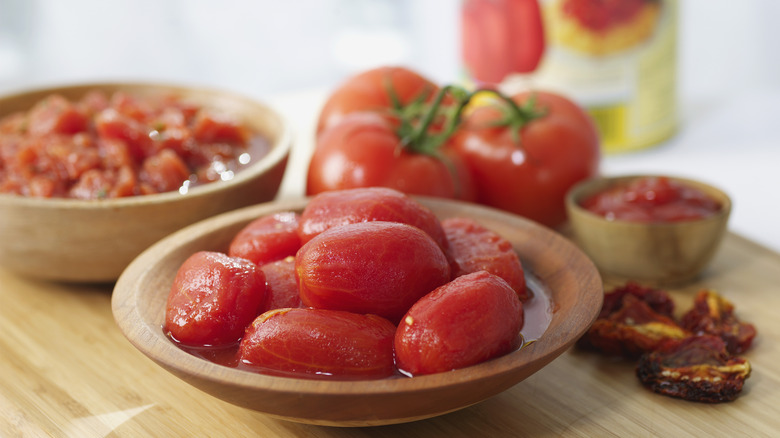 Peeled tomatoes wooden bowls