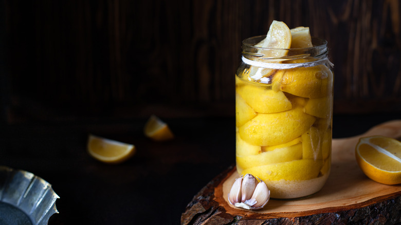 dark background preserved lemons in glass jar