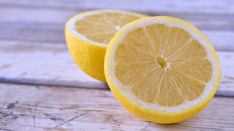 half lemons on wooden table 