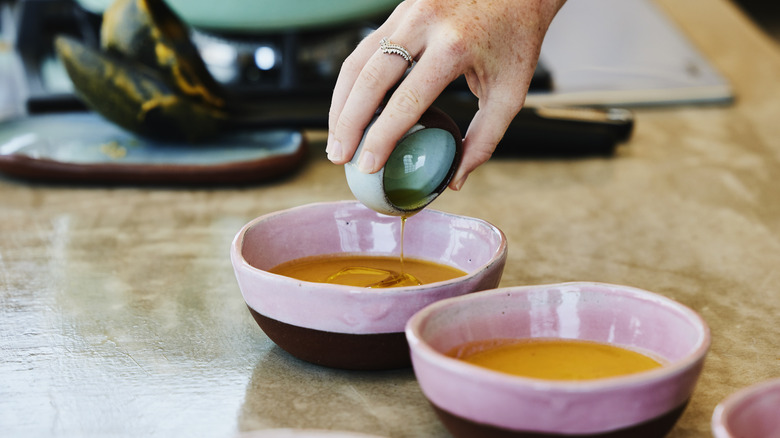 adding olive oil to soup 