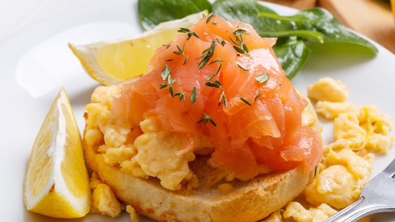 smoked salmon on scrambled eggs on bagel