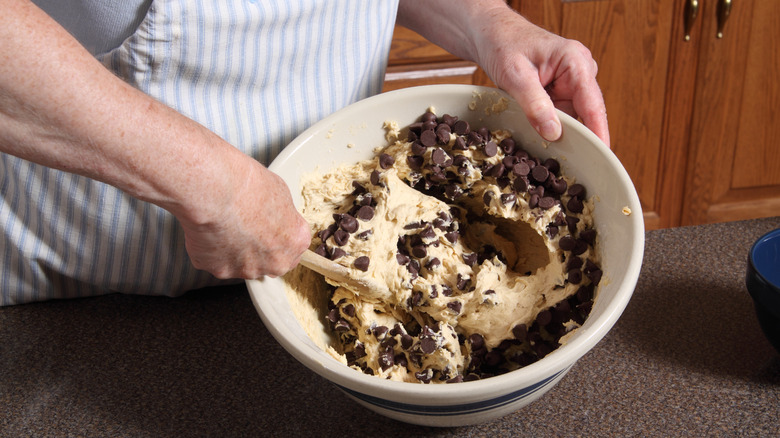 hand mixing chocolate chip cookie dough