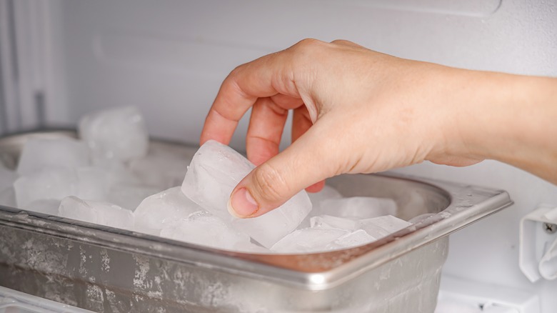 person taking ice from tray