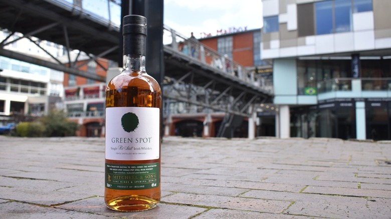 bottle of Green Spot whiskey in street