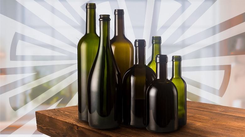 Various large and small wine bottles on a wooden table