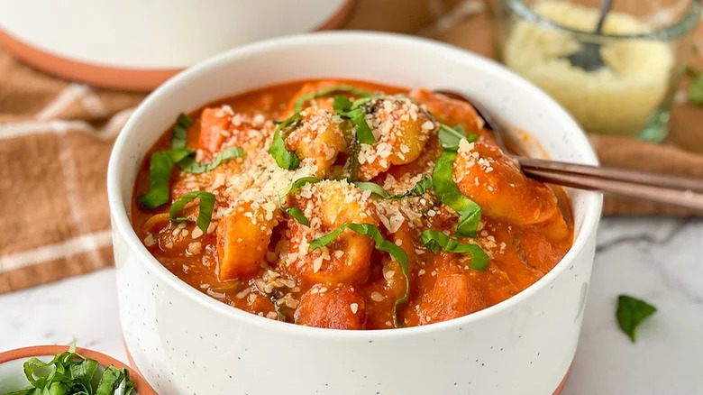 White bowl with creamy tomato tortellini soup