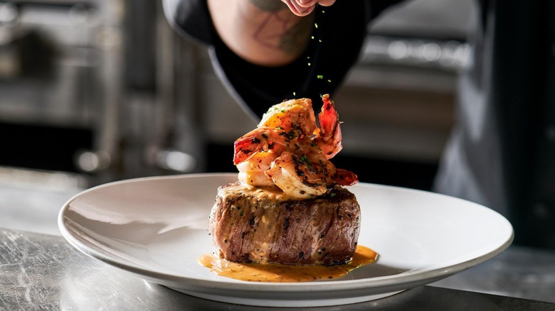 Sprinkling herbs on steak