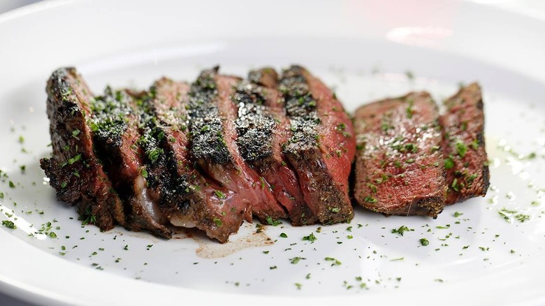 Sliced pink steak and herbs