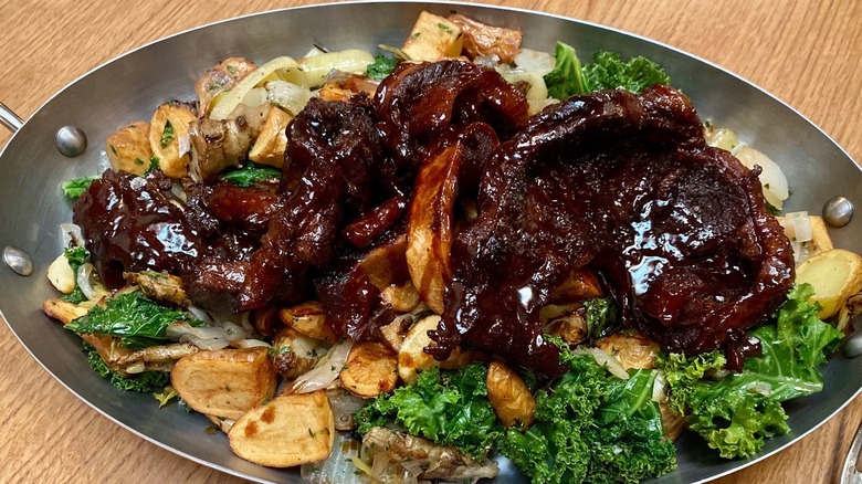 Braised beef shank over salad