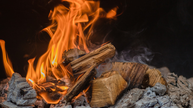 Burning hickory wood in smoker