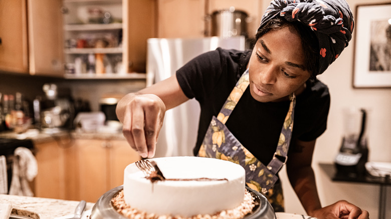 Person decorating cake