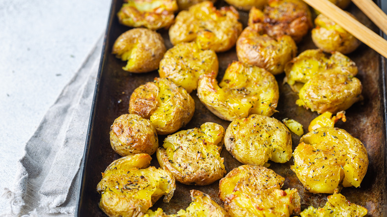 Roasting tray of smashed potatoes