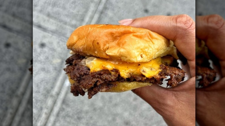 Cheeseburger in a hand