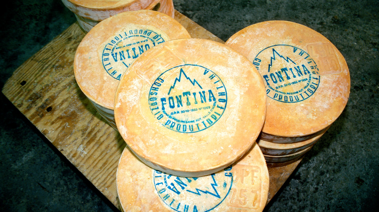 Stacked wheels of fontina cheese